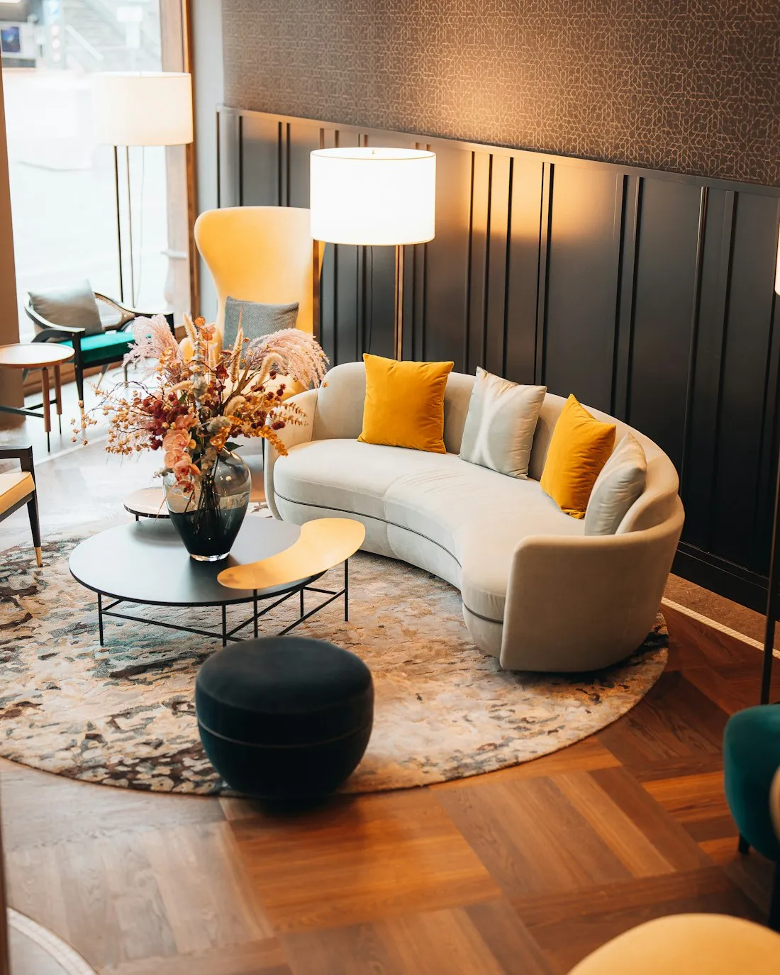 Warm communal lounge with a curved sofa in a modern student residence